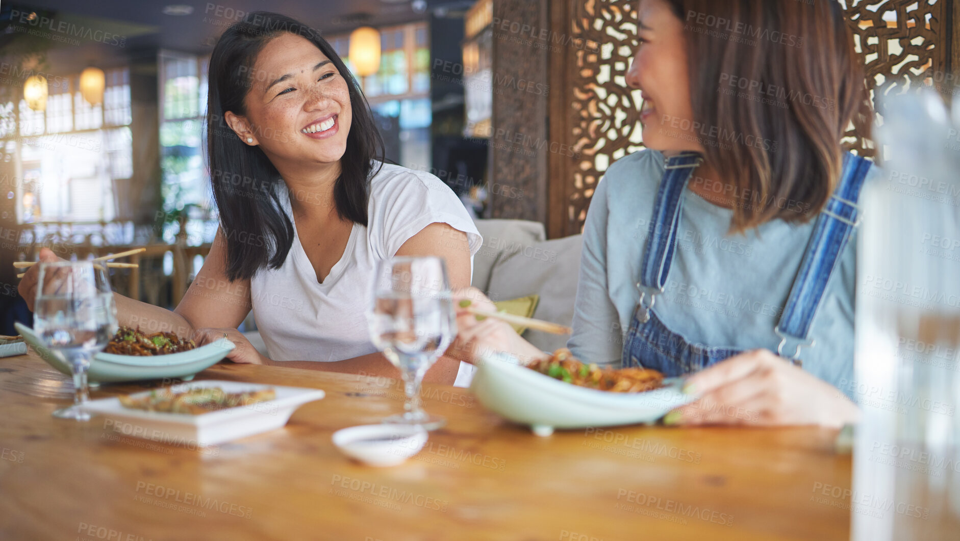 Buy stock photo Sushi, restaurant and women friends with noodles, chopsticks and fish dish. Lunch, hungry Asian female person and Chinese meal with a friend happy from bonding and eating together at a table 