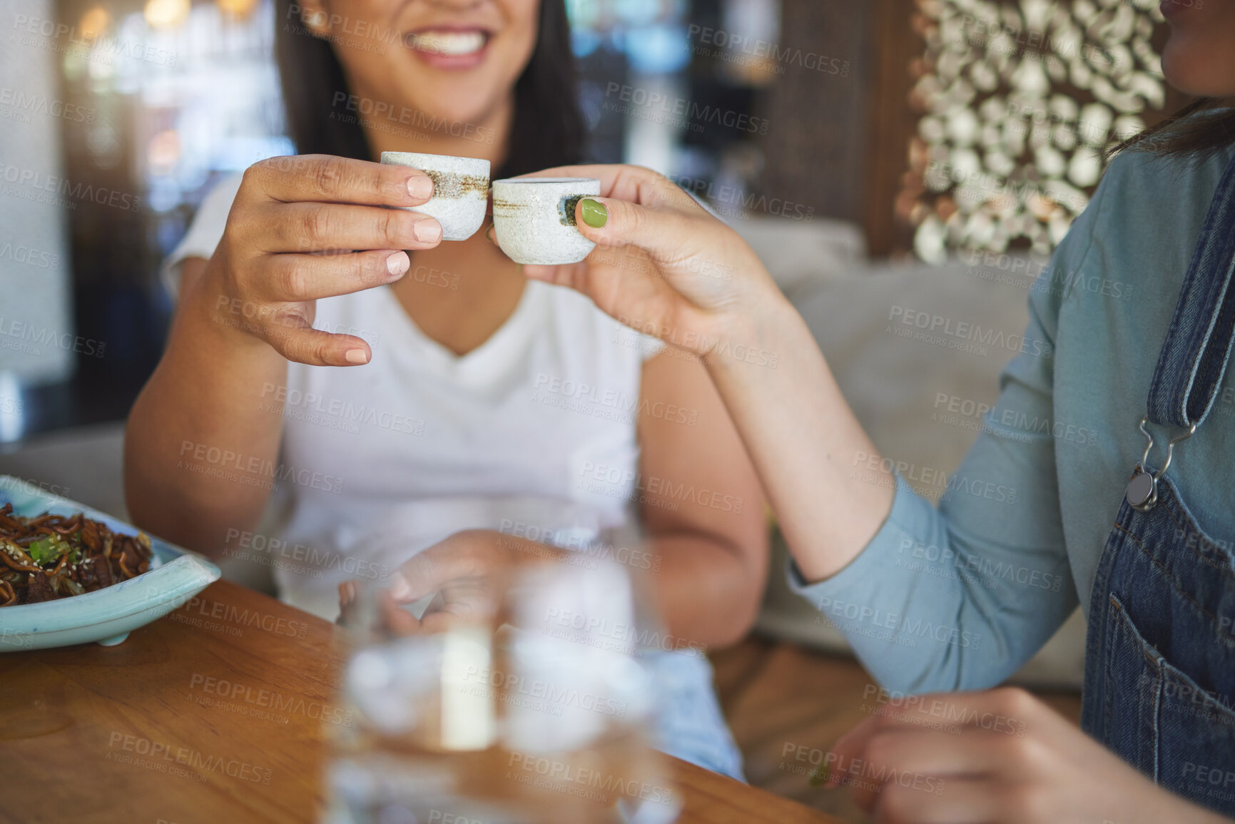 Buy stock photo Hands, toast and restaurant with drink, alcohol or friends for congratulations, celebration or party. Women, event and  saki glasses for cheers, thanks or gratitude for eating, food or event in diner