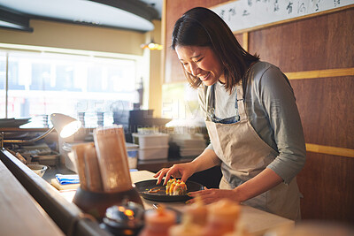 Buy stock photo Sushi, restaurant worker and woman with smile from food and Asian meal in a kitchen. Happy, female waiter or chef working with fish and rice for lunch order with cooking in Japanese bar with service