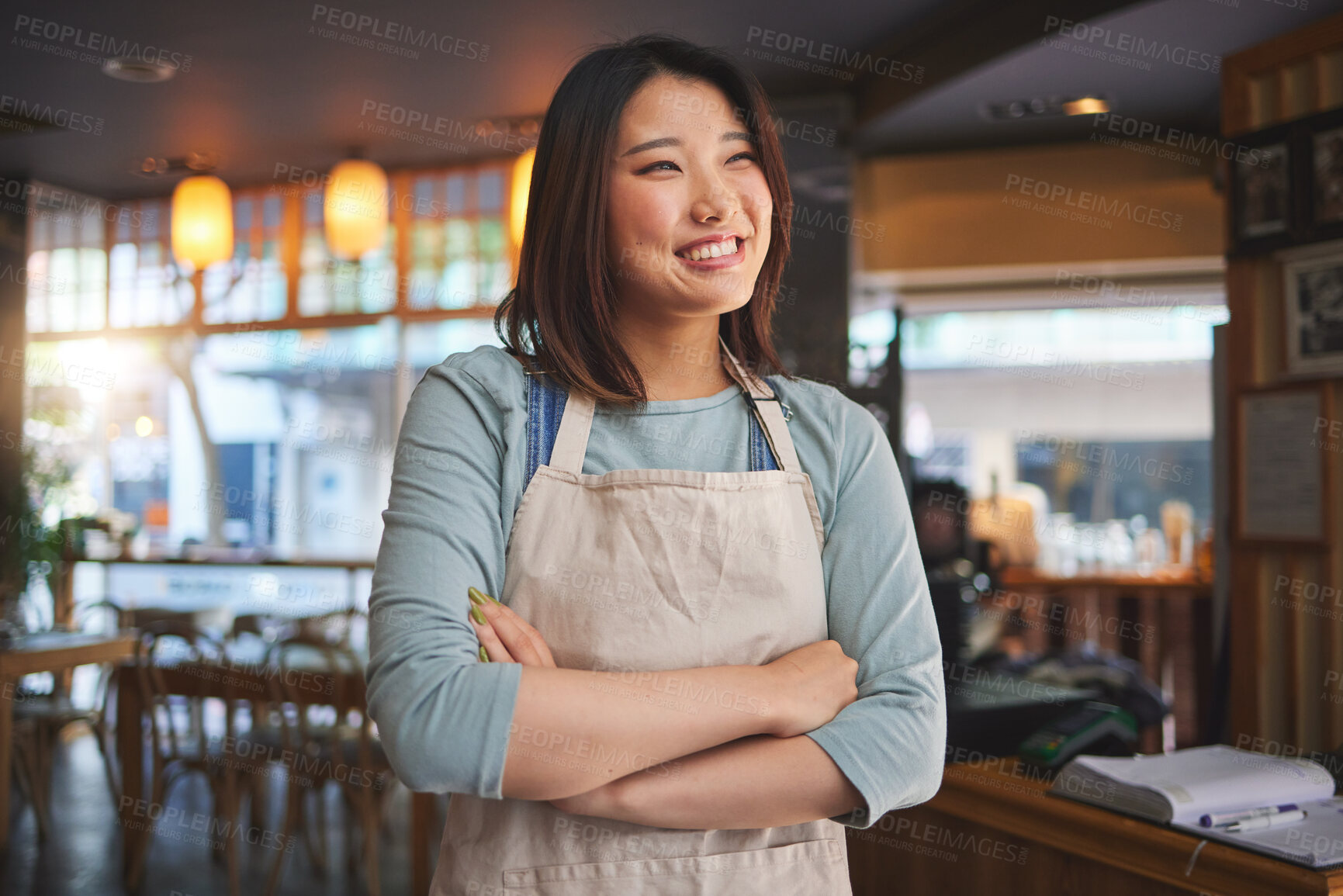 Buy stock photo Smile, thinking and arms crossed with an asian woman in a restaurant working as a waitress for service. Hospitality, happy and idea with a young employee in a chinese eatery for local cuisine