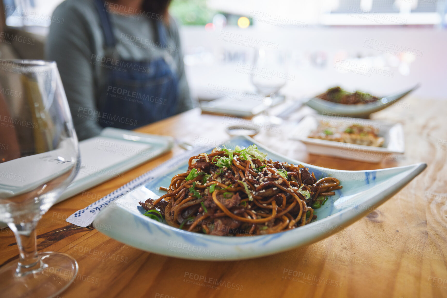 Buy stock photo Plate, eating and noodles at a restaurant on a table for Chinese food at lunch. Closeup, health and Asian cuisine for dinner, hungry or a meal at a fine dining cafe for a traditional snack or supper