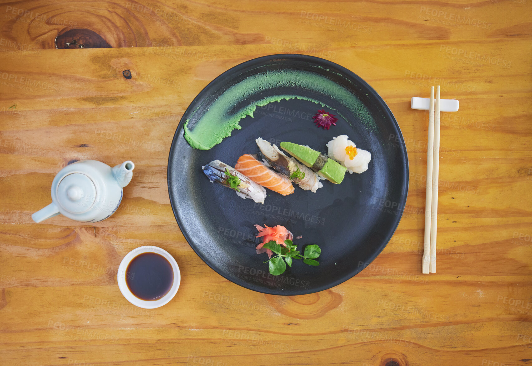 Buy stock photo Sushi, food and chopsticks in an asian restaurant from above for fine dining or traditional cuisine. Salmon, menu and seafood with a chinese dish on a table in a local eatery for hunger or nutrition