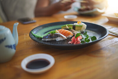 Buy stock photo Sushi, food and chopsticks in a chinese restaurant closeup for fine dining or traditional cuisine. Salmon, menu and seafood with an asian dish on a table in a local eatery for hunger or nutrition