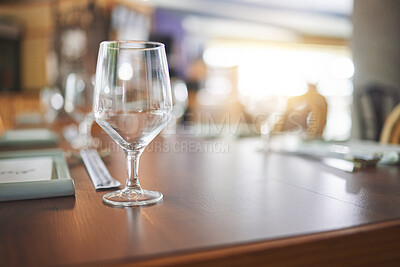 Buy stock photo Bokeh, lunch and glass on a table at a restaurant for water, alcohol or wine. Dinner, crystal and tableware for a drink at a coffee shop or cafe during dinner for a luxury and fine dining experience