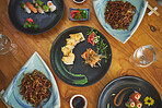Sushi restaurant, catering and plate in top view for service, lunch or dinner with noodles, chopsticks or fish. Japanese cuisine, table and food in diner, cafe or luxury for health, nutrition or diet
