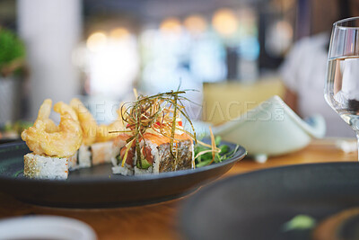 Buy stock photo Sushi restaurant, catering and seafood in closeup for service, brunch or dinner with wine, glass and fish meal. Japanese cuisine, menu and table in diner, cafe or luxury for health, nutrition or diet