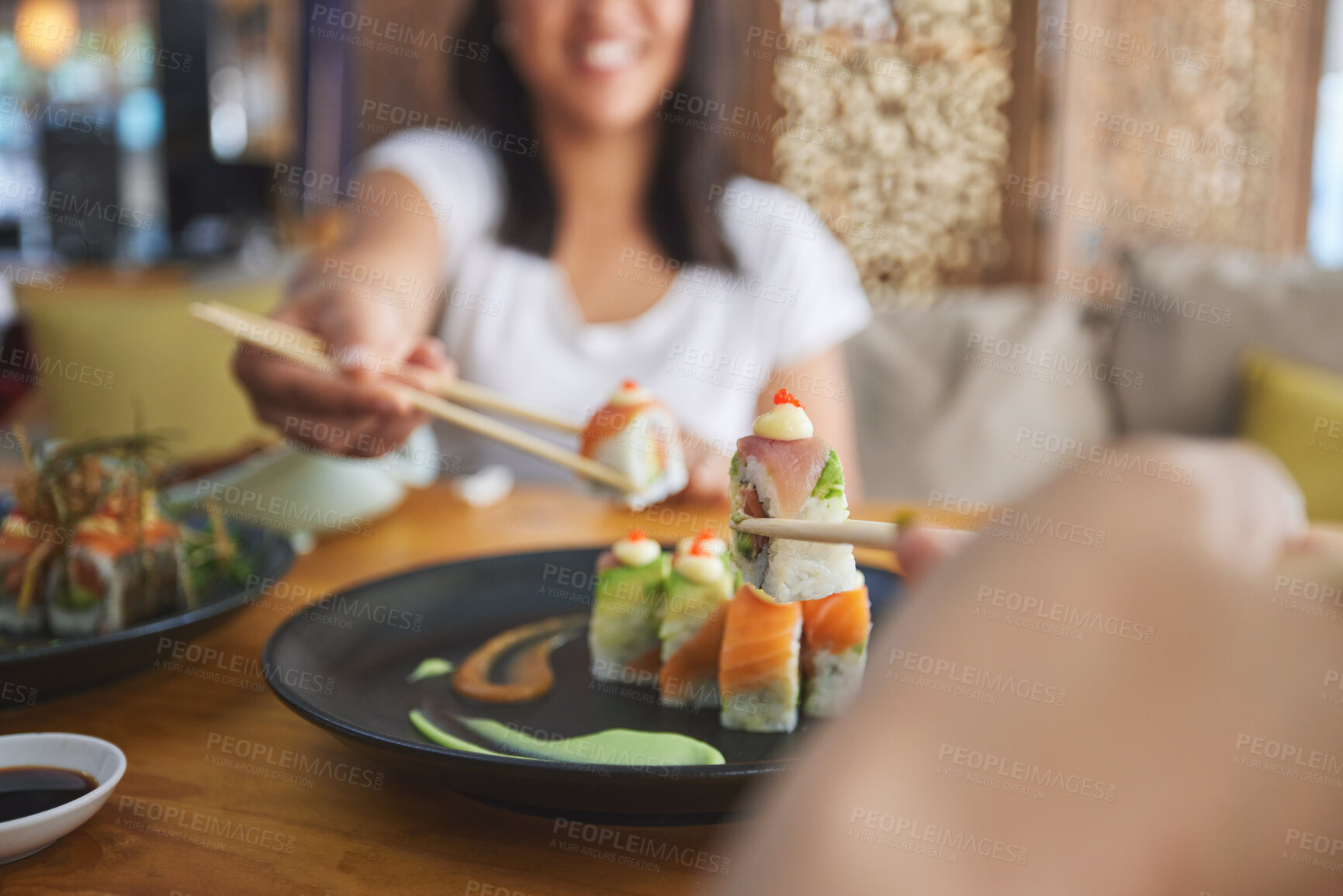 Buy stock photo Hands, chopsticks and sushi restaurant with friends, smile and excited for fine dining, party and share. Happy women, fish and healthy with culture, traditional or fast food in diner, bar or shop