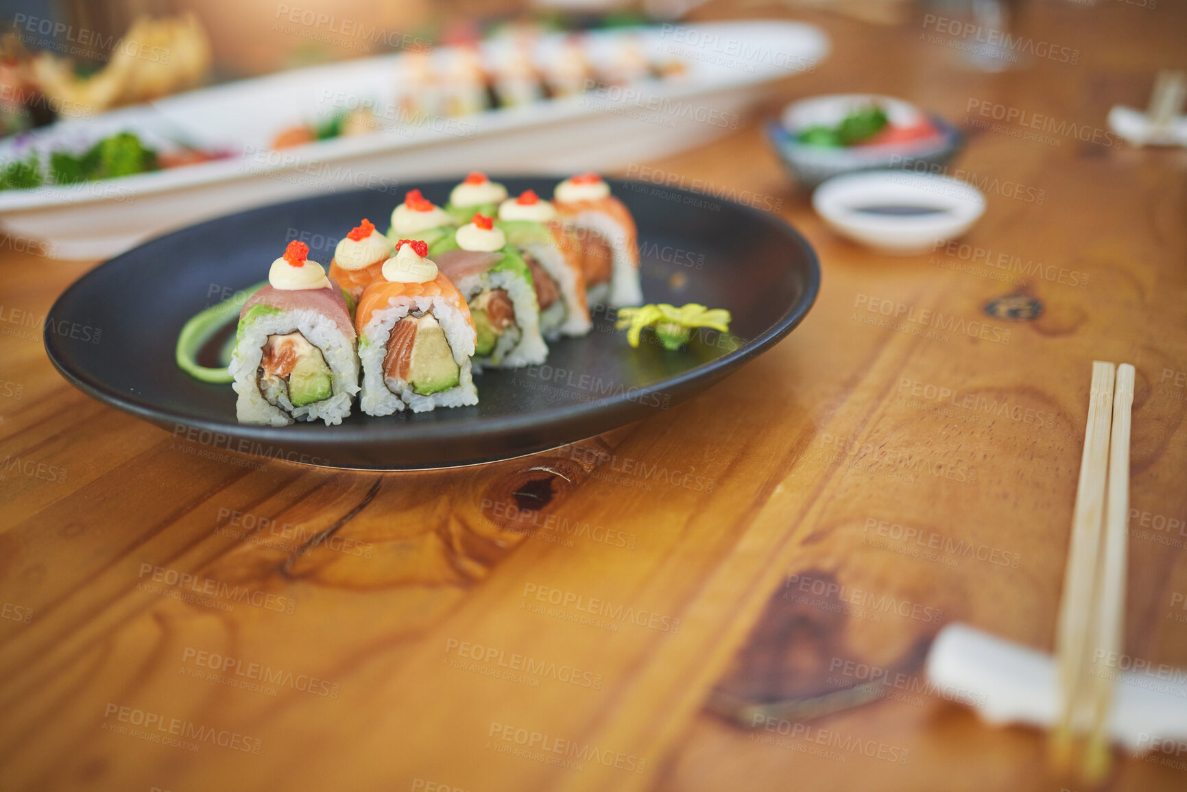 Buy stock photo Restaurant, meal and closeup of sushi on a plate for luxury, healthy and authentic Asian cuisine. Platter, fine dining and zoom of a Japanese food for lunch, dinner or supper at a traditional cafe.