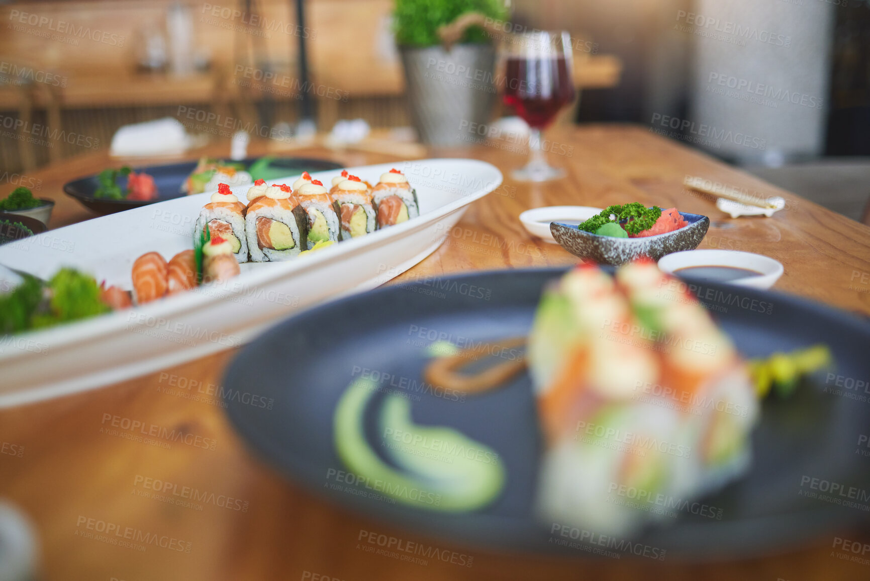 Buy stock photo Sushi, chinese food and chopsticks in an asian restaurant closeup for fine dining or traditional cuisine. Salmon, menu and seafood with a dish on a table in a local eatery for hunger or nutrition