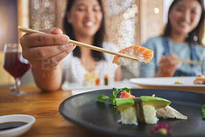 Buy stock photo Japanese woman, chopsticks and nigiri in restaurant, smile and excited for fine dining at party. Asian friends, fish and healthy with culture, traditional and fast food in diner, sushi bar or store