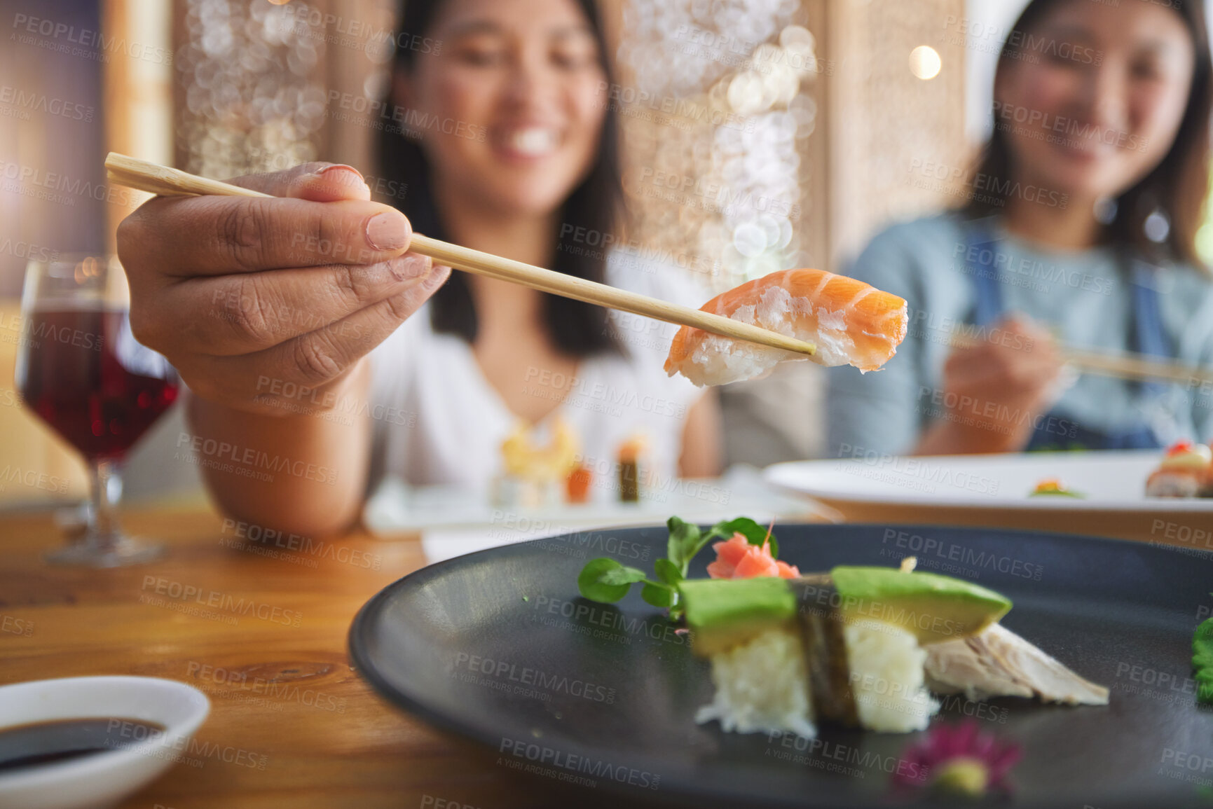 Buy stock photo Japanese woman, chopsticks and nigiri in restaurant, smile and excited for fine dining at party. Asian friends, fish and healthy with culture, traditional and fast food in diner, sushi bar or store