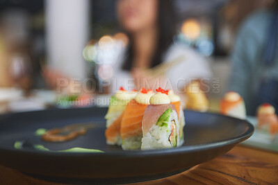 Buy stock photo Restaurant, food and closeup of sushi on a plate for luxury, healthy and authentic Asian cuisine. Platter, fine dining and zoom of a Japanese meal for lunch, dinner or supper at a traditional cafe.