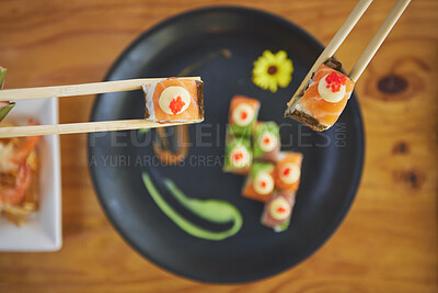 Buy stock photo Sushi, seafood and chopsticks in a chinese restaurant from above for dining or traditional cuisine. Salmon, menu and raw food with am asian dish on a table in a local eatery for hunger or nutrition