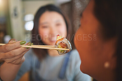 Buy stock photo Chopsticks, restaurant feeding and friends hands with sushi and Asian cuisine eating at cafe. Happy, hungry women and plate of food at Japanese bar with friendship, smile and bonding from table meal