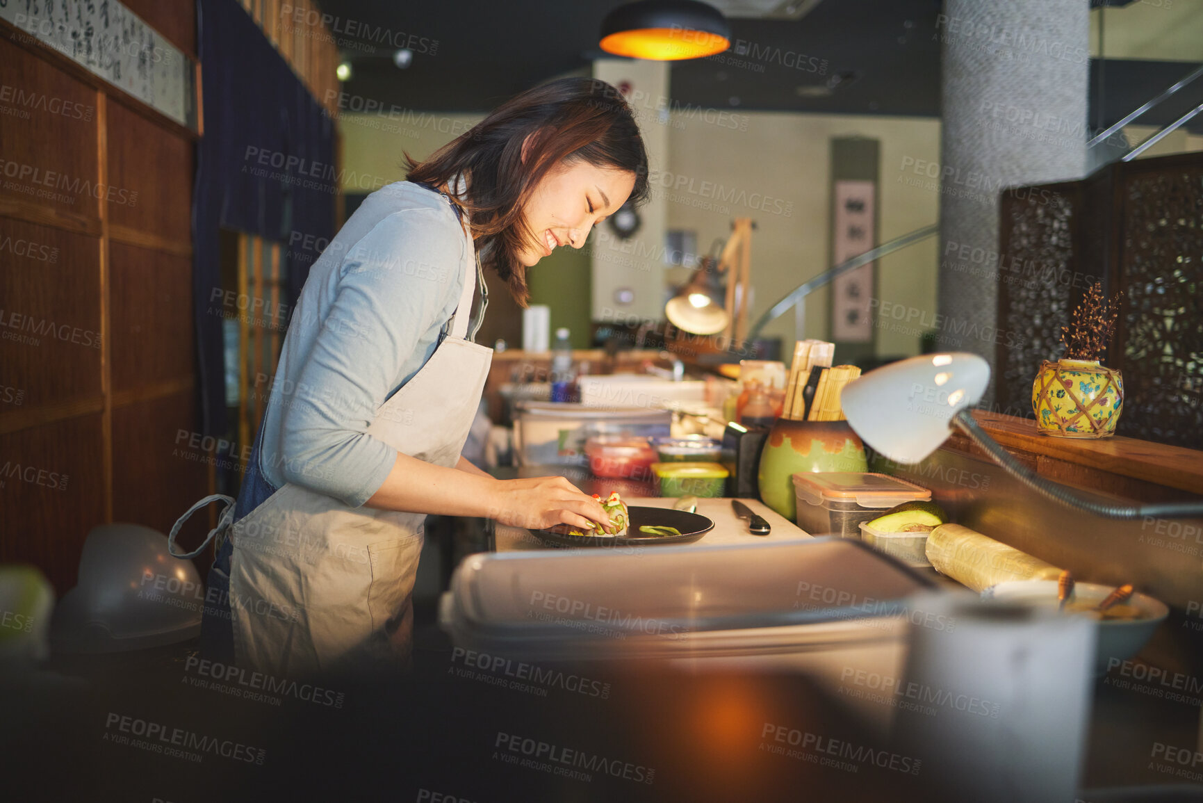 Buy stock photo Sushi chef, restaurant and prepare in kitchen with start, service or plate on table, job or catering. Small business, fast food and cooking in cafe, startup diner and smile with fish, rice or seaweed