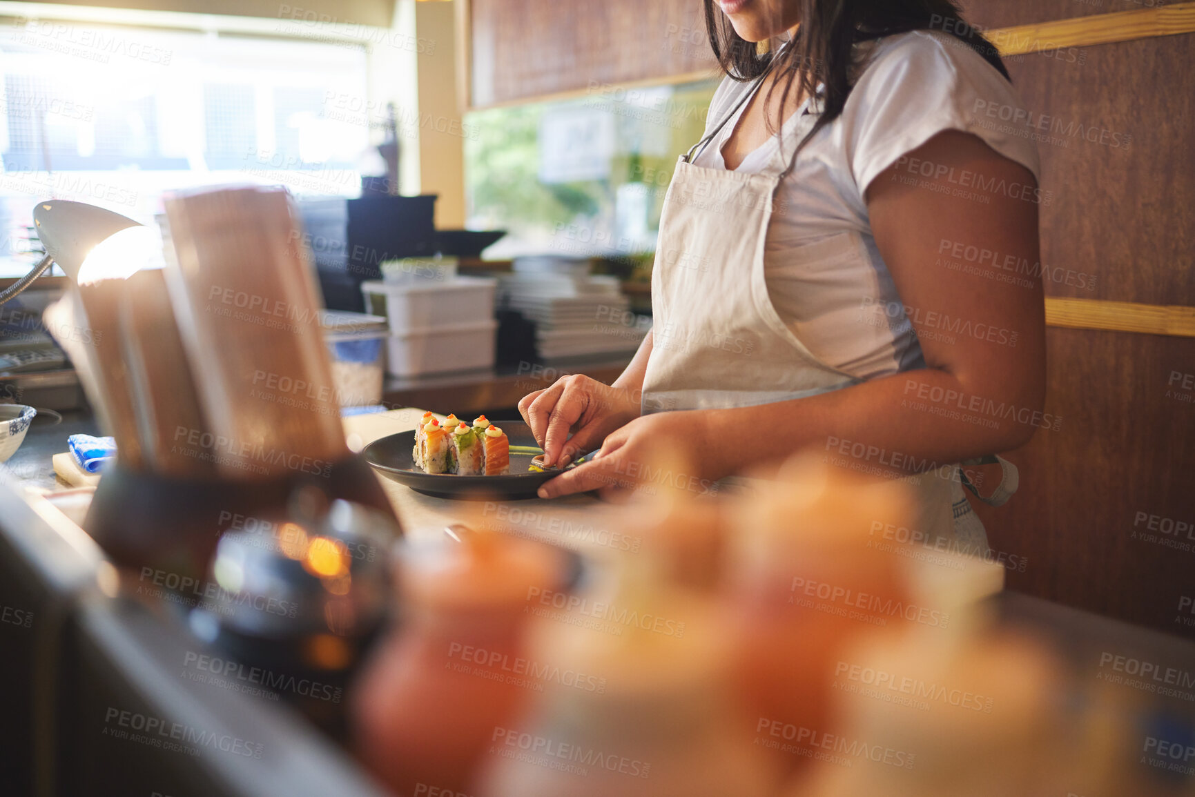 Buy stock photo Cooking, sushi and chef with hands of person in restaurant for seafood, Japanese cuisine and nutrition. Fish, lunch and health with closeup of woman in kitchen of store for menu, takeaway and diet