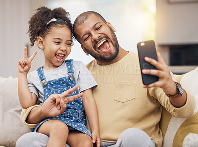 Buy stock photo Father, girl and peace sign selfie in home living room, bonding and funny together. Dad, child and excited in v hand on profile picture, happy memory or social media post of family laughing on sofa