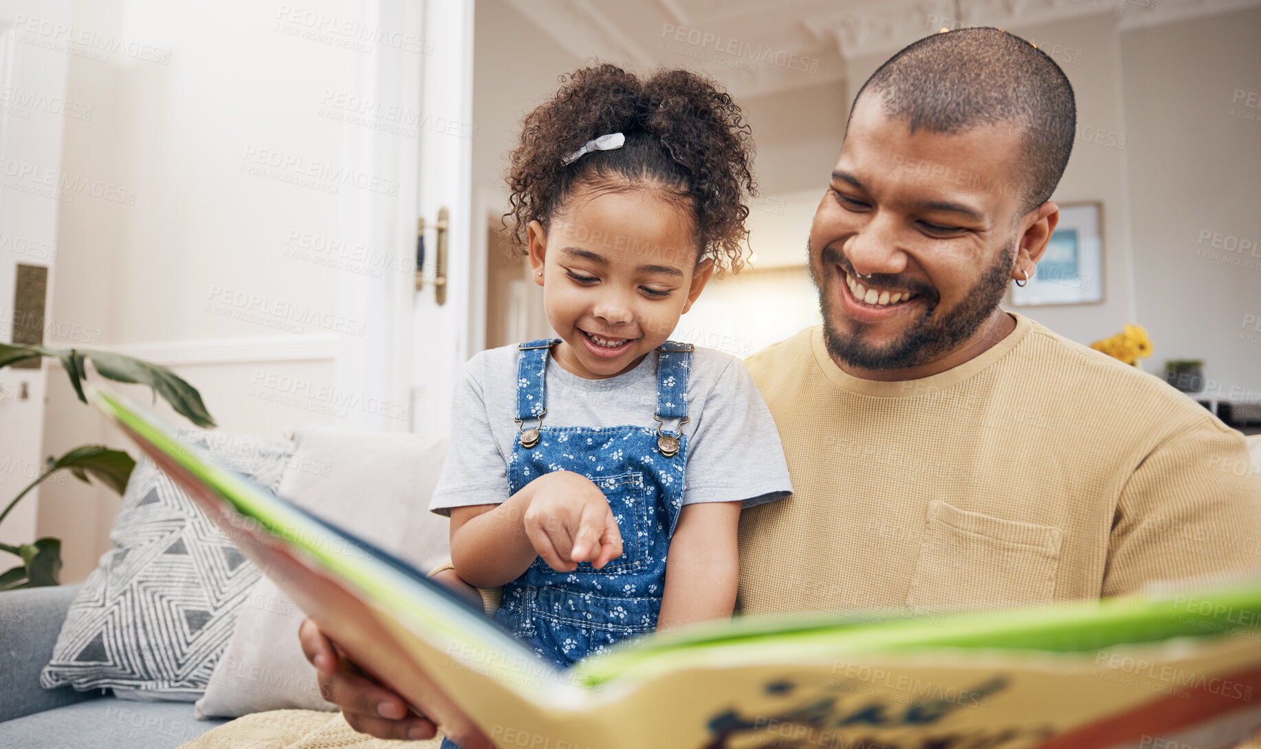 Buy stock photo Dad, daughter and book on sofa together, bonding and love in storytelling in living room with smile. Happiness, father and child reading story on couch for fantasy, learning and education in home fun