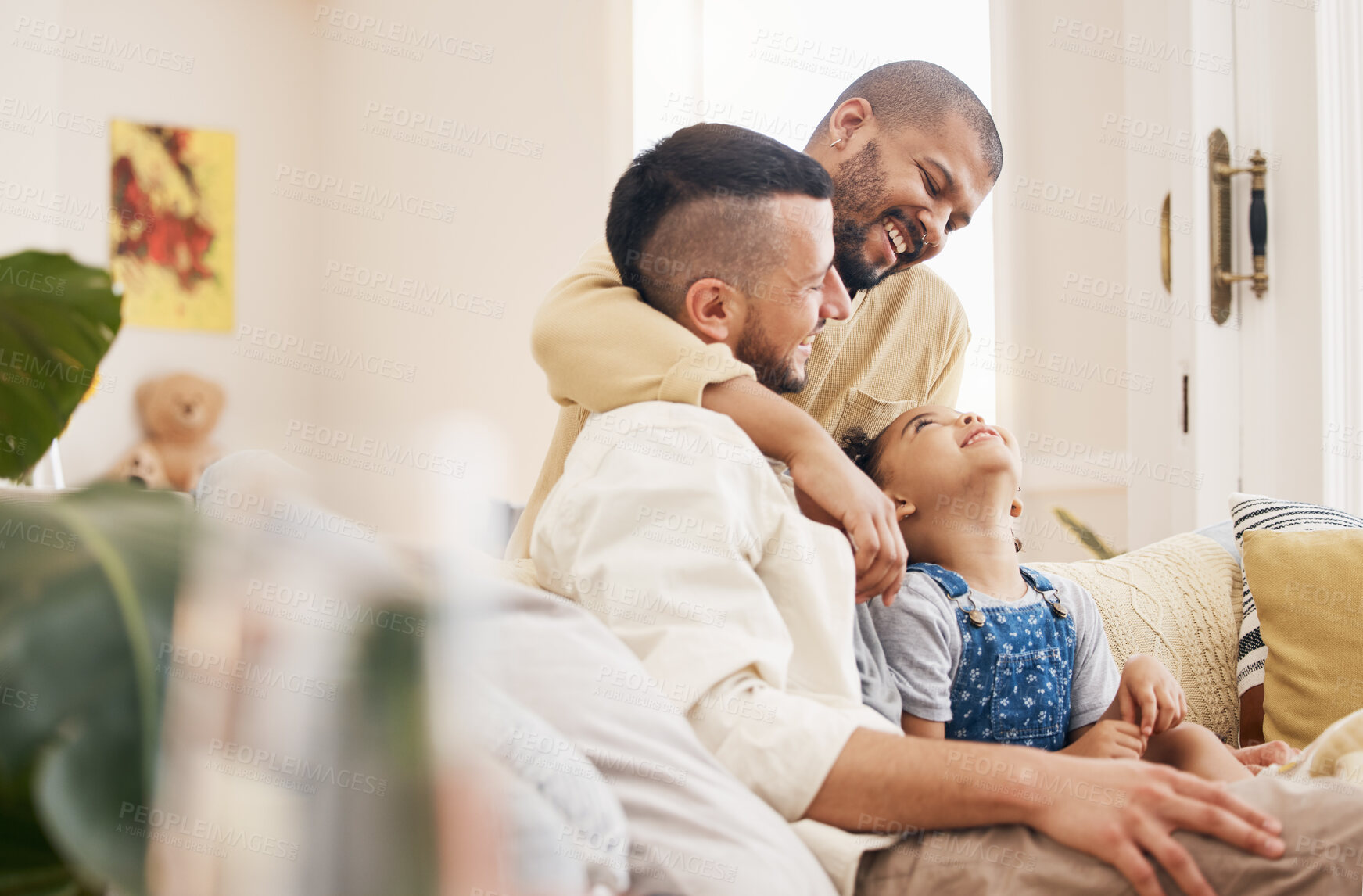 Buy stock photo Gay, happy family and a child hug on a home sofa with love, care and safety in a lounge. Lgbtq men, adoption and parents with a foster girl kid together on a couch for happiness, bonding and to relax