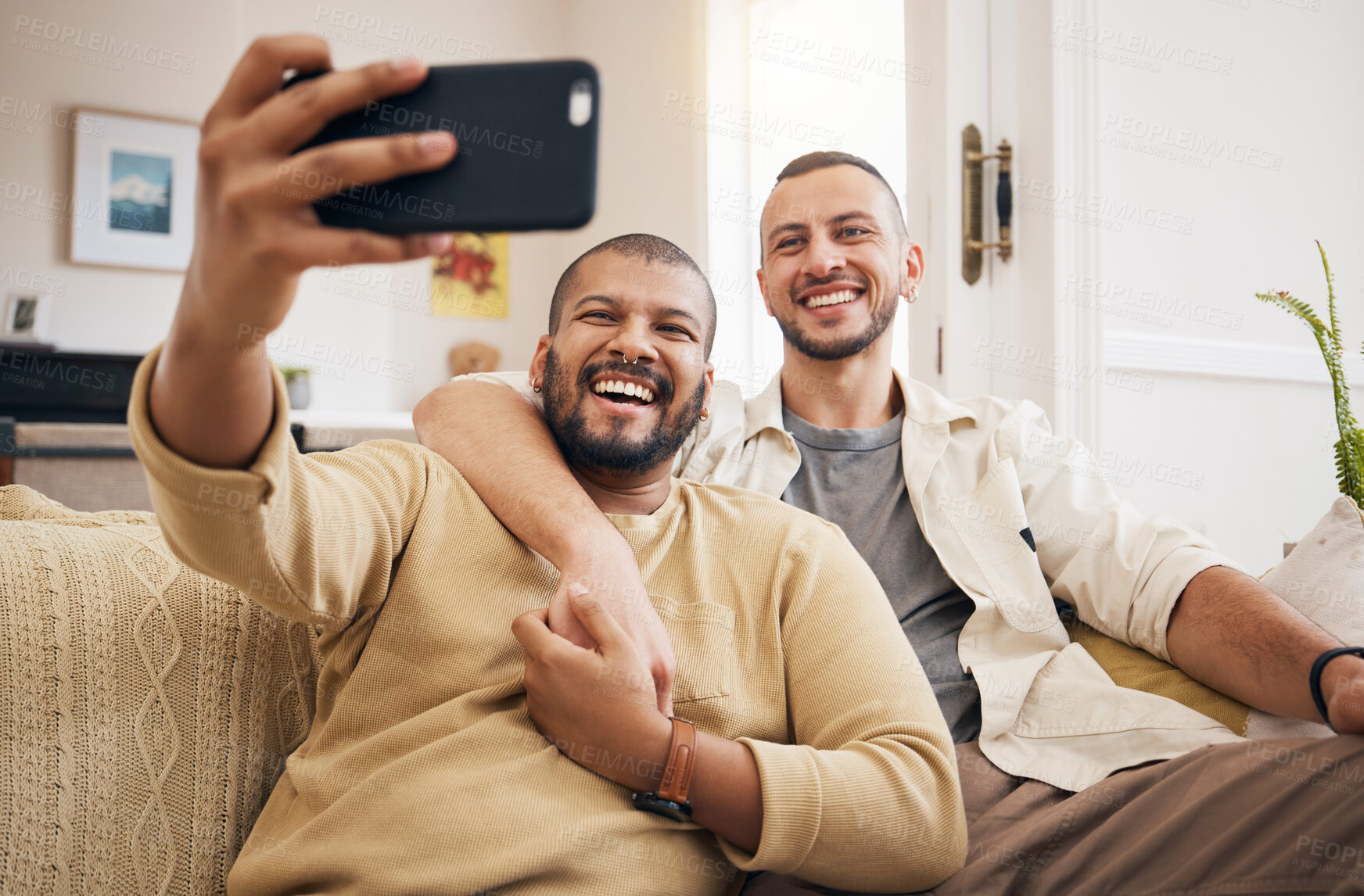 Buy stock photo Men, lgbtq couple and funny selfie in home living room, bonding and laughing together. People, gay and profile picture, happy memory or smile on social media in love, care and interracial hug on sofa