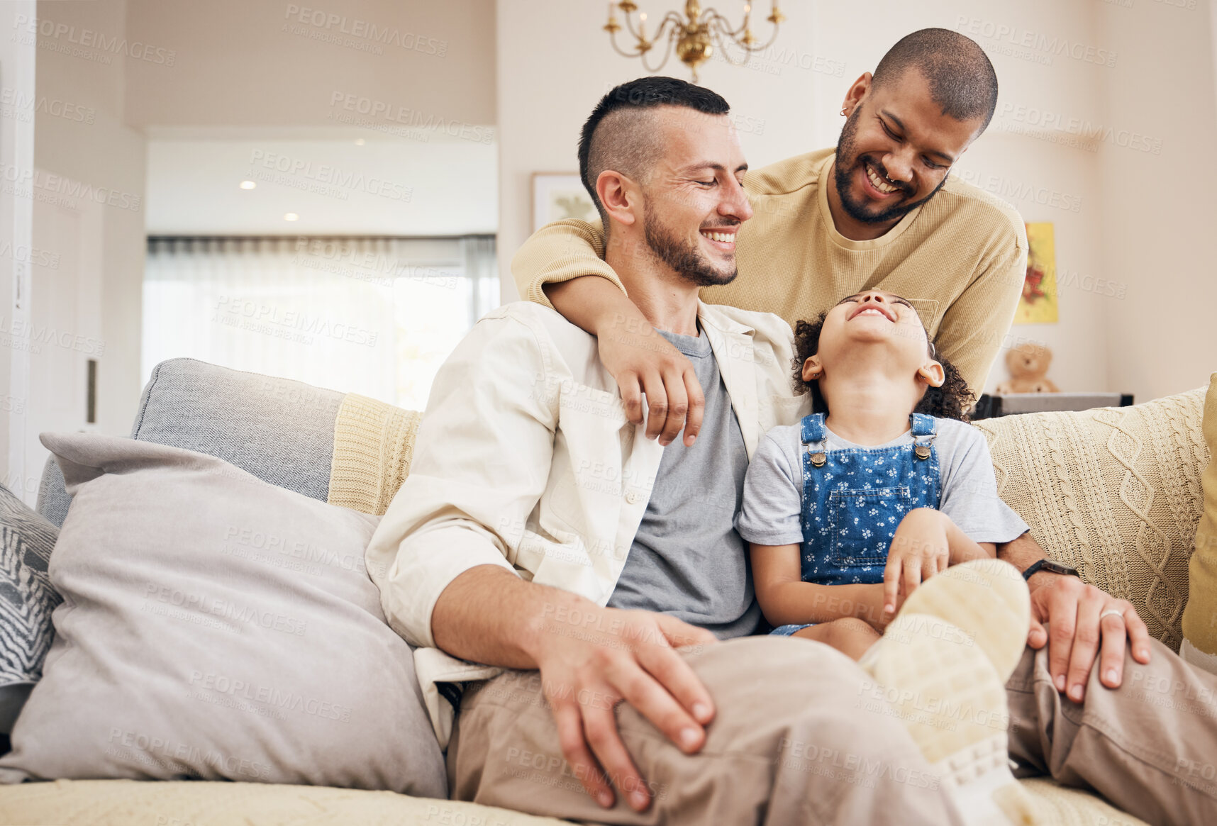 Buy stock photo Gay family, child and happy on a home sofa with love, care and safety in a lounge. Lgbtq men, adoption and interracial parents with a girl kid together on a couch for happiness, bonding and relax