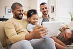 Gay family, tablet and child on home sofa for learning, communication and education on internet. Adoption, lgbt men or parents with a happy kid and technology for streaming movies, games and videos