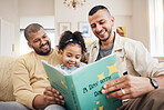 Gay couple, kid and book on couch with smile, bonding and love in storytelling in living room together. Happiness, lgbt men and girl reading story on sofa for fantasy, learning and education in home.