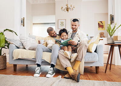 Buy stock photo Gay parents on a couch, girl and reading book with a smile, home and education with bonding, relax and weekend break. Fathers, female child and kid with lgbtq, storytelling and fairytale in a lounge