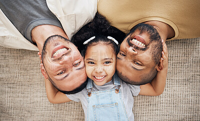 Buy stock photo Portrait, gay dad and blended family with a girl lying together on the floor of the home for adoption from above. LGBT love, children or kids and a daughter with her happy foster parents in the house