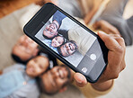 Selfie, gay dad and blended family with a girl lying together on the floor of the home for a photograph from above. LGBT love, children or kids and a daughter with her happy parents taking a picture