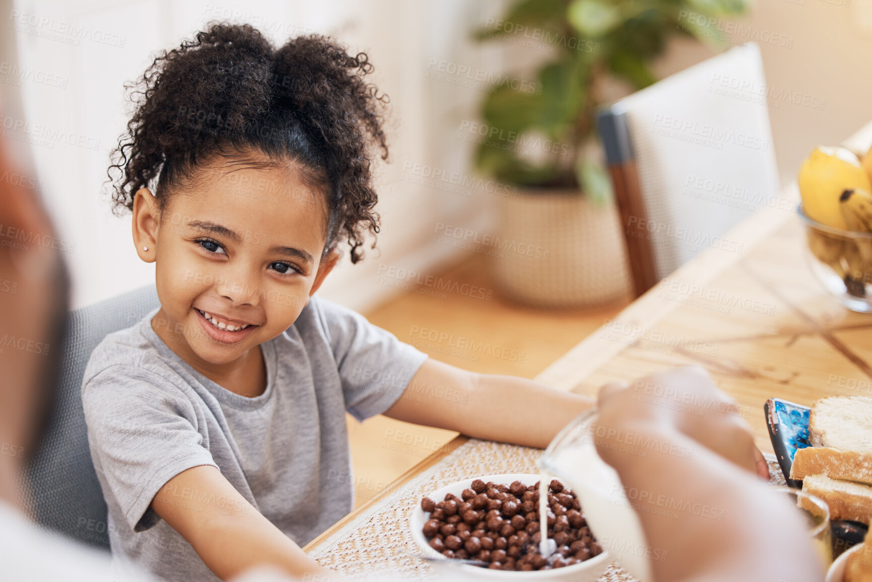 Buy stock photo Kitchen, breakfast cereal and happy family child smile for morning food, meal and parent pour milk. Home, happiness and young kid, youth girl and ready for nutrition, hungry and eating in Brazil