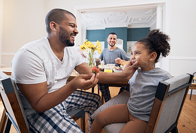 Buy stock photo Gay couple, breakfast or child with father wipe, cleaning or remove food, morning meal or cereal from mouth of girl. Happy family, adoption or non binary dad smile for hungry youth kid eating at home