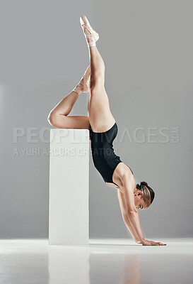 Buy stock photo Balance, ballerina or woman in studio on a handstand, block or platform for elegant routine or creative freedom. Flexible, dancer or girl ballet dancing or training to exercise on white background