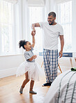 Dad, girl and ballet dancing in house, holding hands or help for training, comic smile or tutu in game. Man, kid and laugh for steps, moving and funny for performance, concert or show in family home