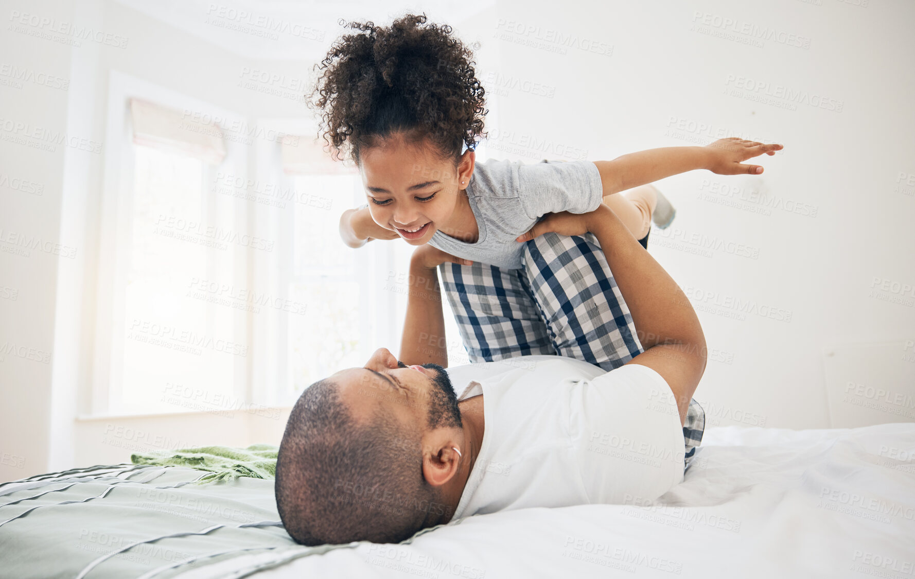 Buy stock photo Dad, child and bed with airplane game, happy bonding and fun morning playing for father and daughter in home. Family, love and playful energy, man holding girl in air and laughing in bedroom together