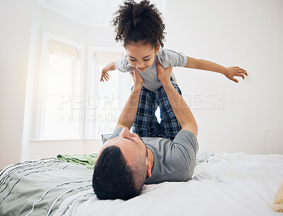 Buy stock photo Happy, fun and dad with child on bed playing, bonding and airplane game for father and daughter in home. Family, love and playful energy, man holding girl in air and laughing in bedroom together.