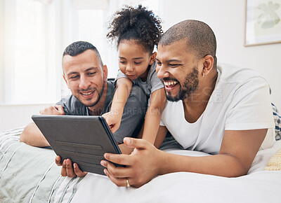 Buy stock photo Gay family, tablet and child on a bed at home for e learning, watch video and education on internet. Adoption, lgbt men or parents with a happy kid and technology for streaming movies, games or app