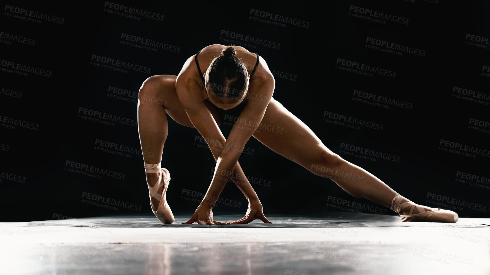 Buy stock photo Art, ballet and woman on black background stretching in dance performance with balance, stage and talent. Dark aesthetic, flexible ballerina or dancer with fitness, creativity and studio exercise.