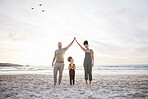 Family, high five and beach for travel, celebration and freedom, bond or fun in nature together. Love, hands together and girl child with parents at sea playing, relax and happy on holiday in Bali
