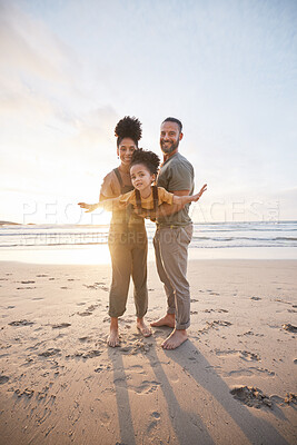 Buy stock photo Parents, girl child and beach with airplane game, smile or portrait for bonding, love or sunset on holiday. Father, mother and daughter for plane, play or interracial family on vacation, waves or sea