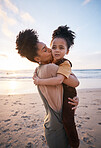 Beach, sunset and mother kissing her child on a family vacation, holiday or travel adventure. Love, care and mom holding, hugging and bonding with her girl kid by the ocean on weekend trip in Mexico.