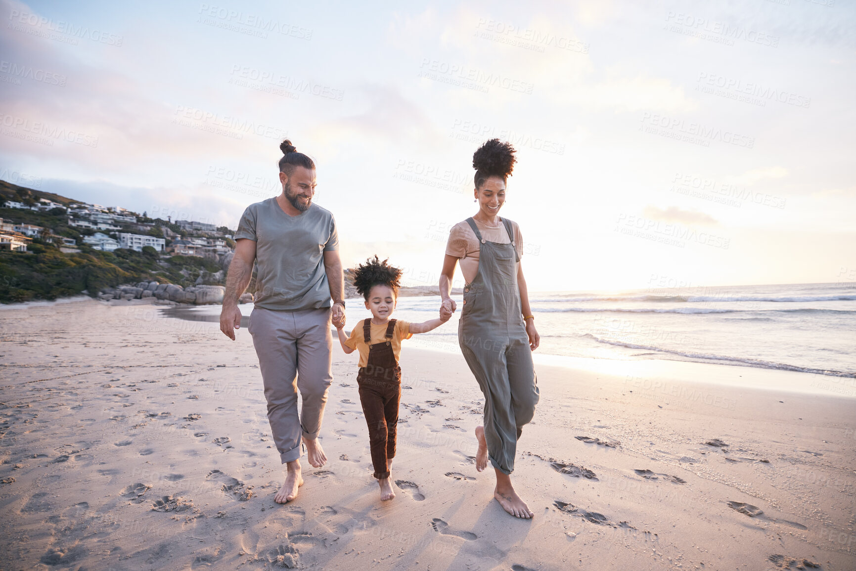 Buy stock photo Family, holding hands and walking on beach at sunset, bonding and mockup space. Father, mother and happy kid at ocean in interracial care, love or smile on vacation, holiday or summer travel together