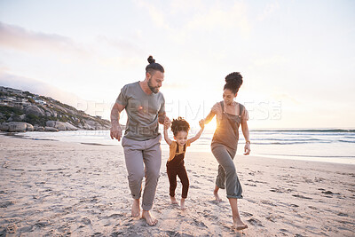 Buy stock photo Family, holding hands and beach for travel, vacation and freedom, bond and fun in nature together. Love, swing and girl child with parents at the ocean playing, relax and walking on summer holiday
