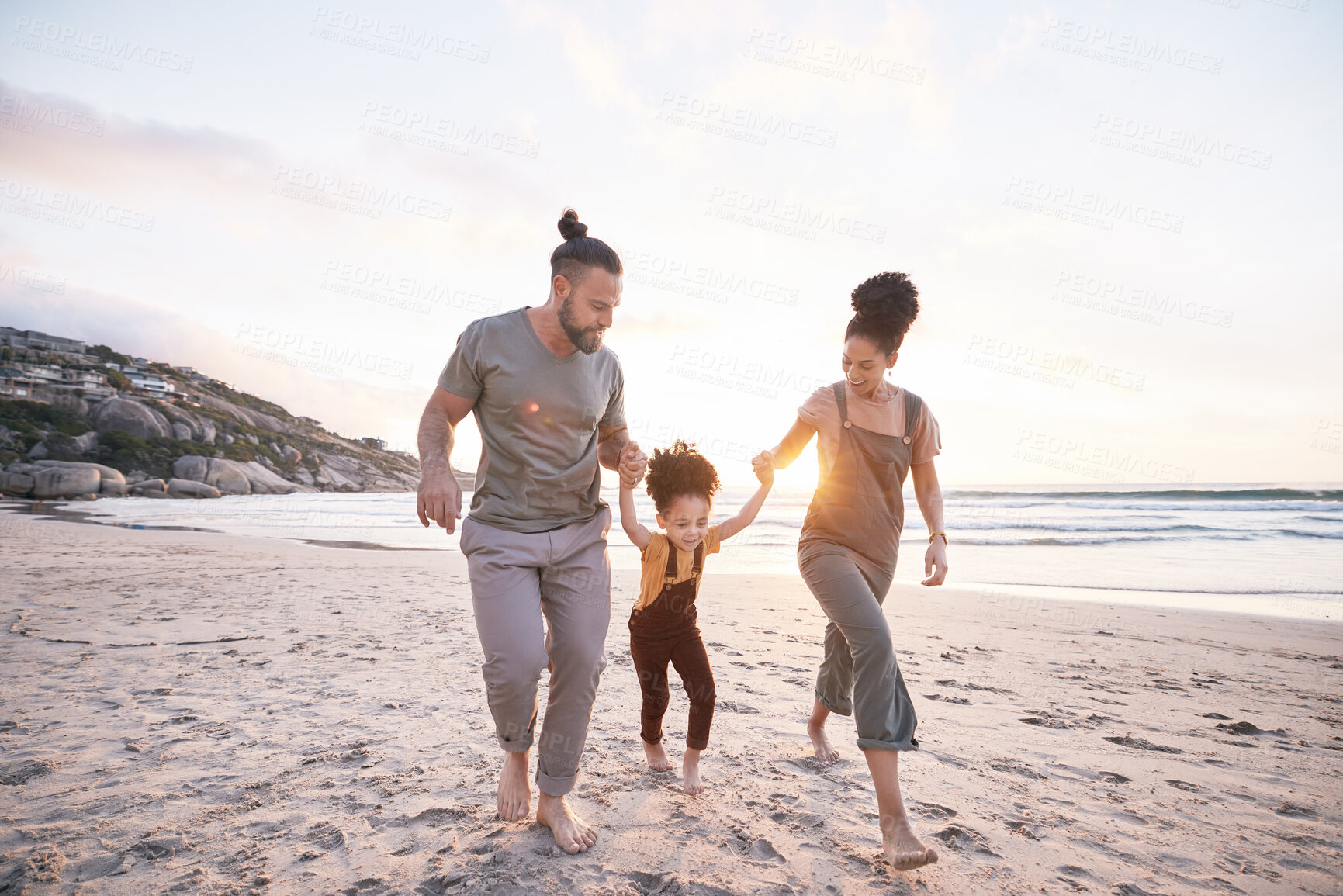 Buy stock photo Family, holding hands and beach for travel, vacation and freedom, bond and fun in nature together. Love, swing and girl child with parents at the ocean playing, relax and walking on summer holiday
