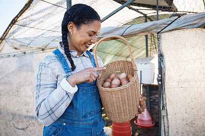 Buy stock photo Happy woman checking eggs in basket at farm chicken coop, inspection and countryside greenhouse at sustainable business. Agriculture, poultry and girl farmer with smile, pride for food and counting.