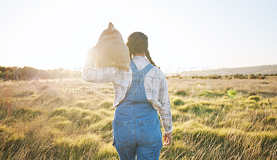 Buy stock photo Walking, sack or farmer farming on grass field harvesting production in small business to trade. Back, supply chain or person working with bag for sustainability or agro development in countryside