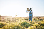 Walking, bag or farmer farming in nature harvesting production in small business to trade. Back, mockup space or woman working with bag for sustainability or agro development on countryside field