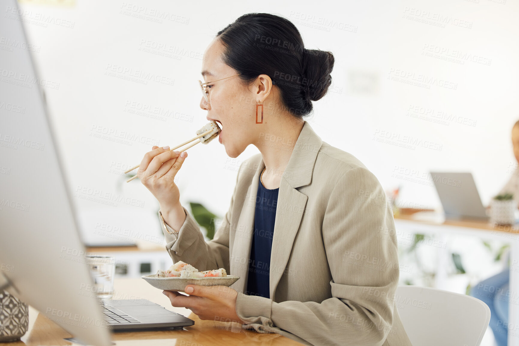 Buy stock photo Lunch break, food and business woman at office desk for meal while reading laptop for email or proposal. Sushi, brunch and hungry designer with takeaway for efficient, productive and time management 