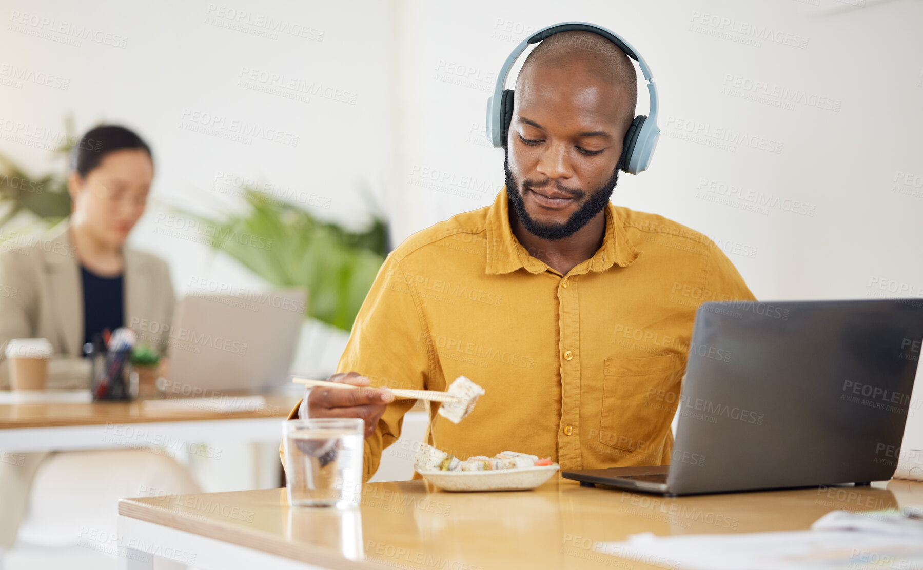 Buy stock photo Delivery, fast food and black man with laptop in office for lunch break, eating and meal. Sushi, brunch and African manager online with positive review, survey or feedback for takeout order service