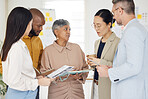 Tablet, collaboration and documents with a business team talking in the office during a meeting. Technology, paper and serious with a manager coaching an employee group in a professional workplace